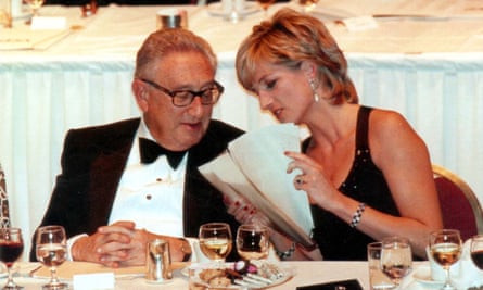 Henry Kissinger with Diana, Princess Of Wales in 1995 at a formal event. They are talking and looking at sheets of paper.