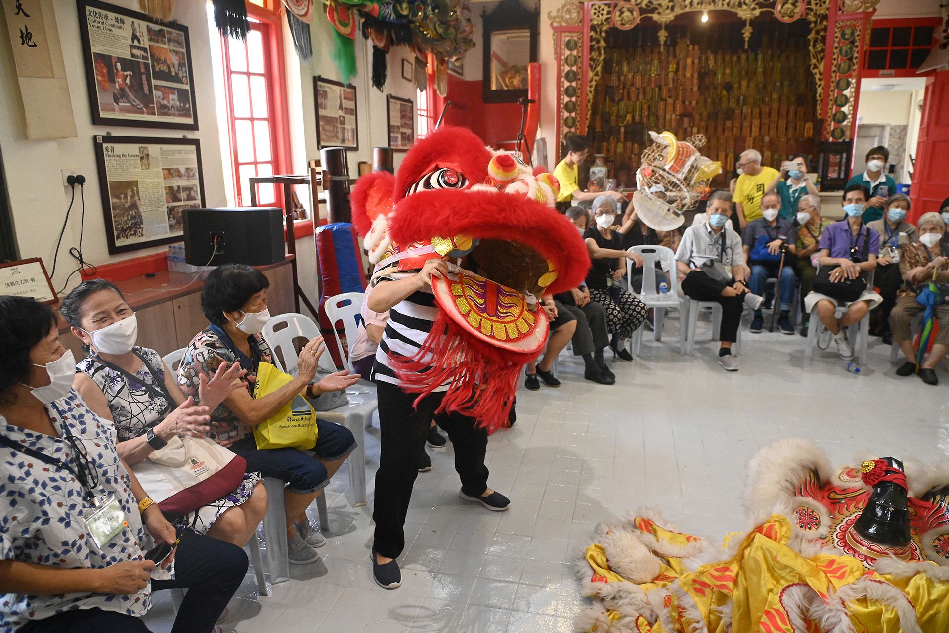 Madam Li Xiao Wei, 69, trying out the lion dance head during the excursion to Kong Chow Wui Koon on Dec 15, 2023.