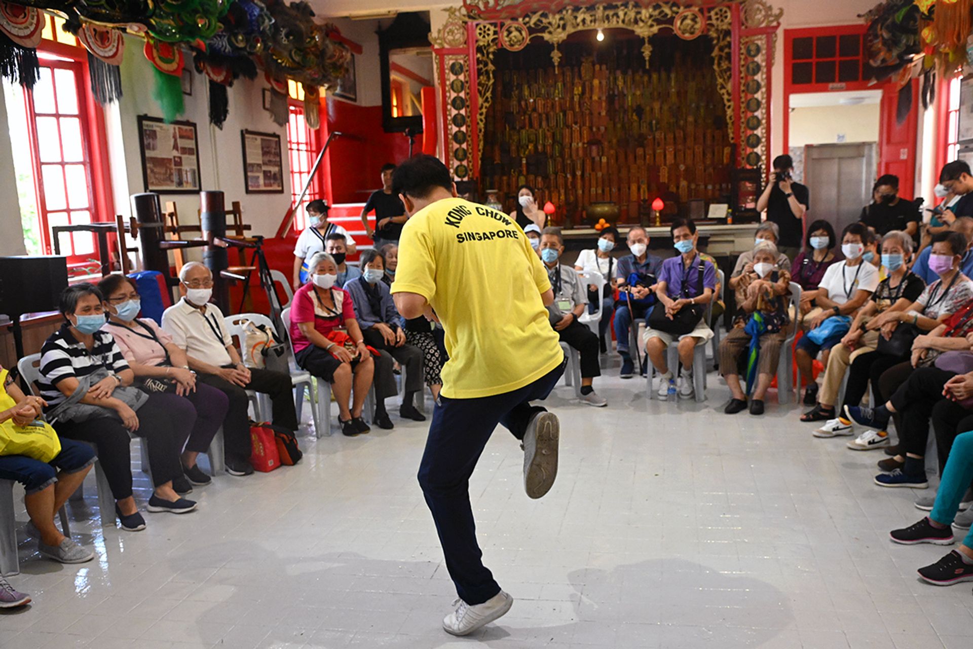 Kong Chow Wui Koon lion dance troupe instructor Leong Kwok Khuen, 56, explaining the horse stance in lion dance to the seniors.