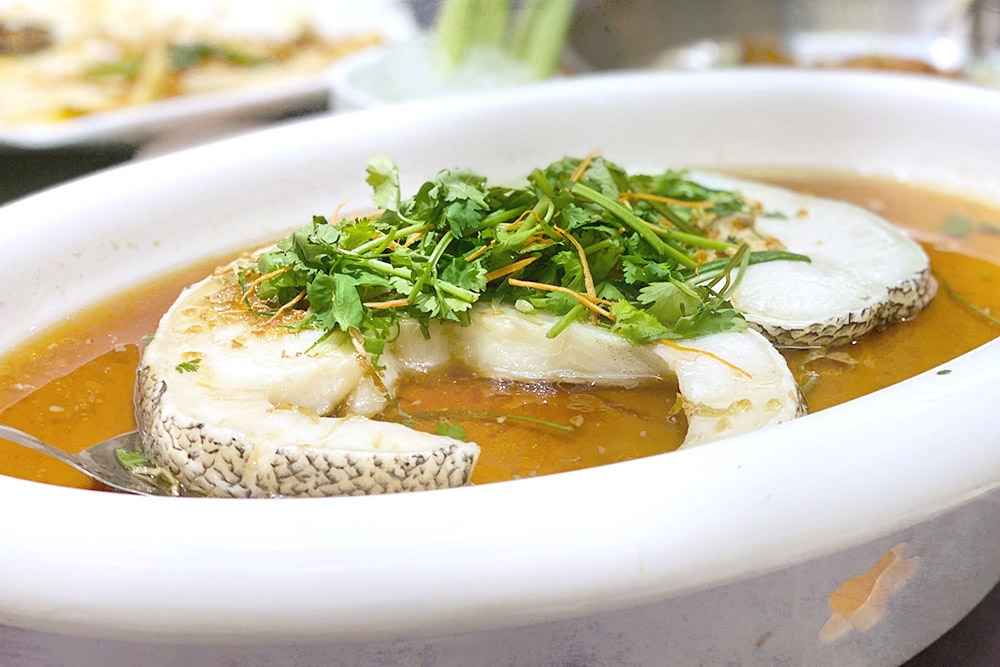 Steamed deep sea cod with homemade soy sauce and fried garlic.