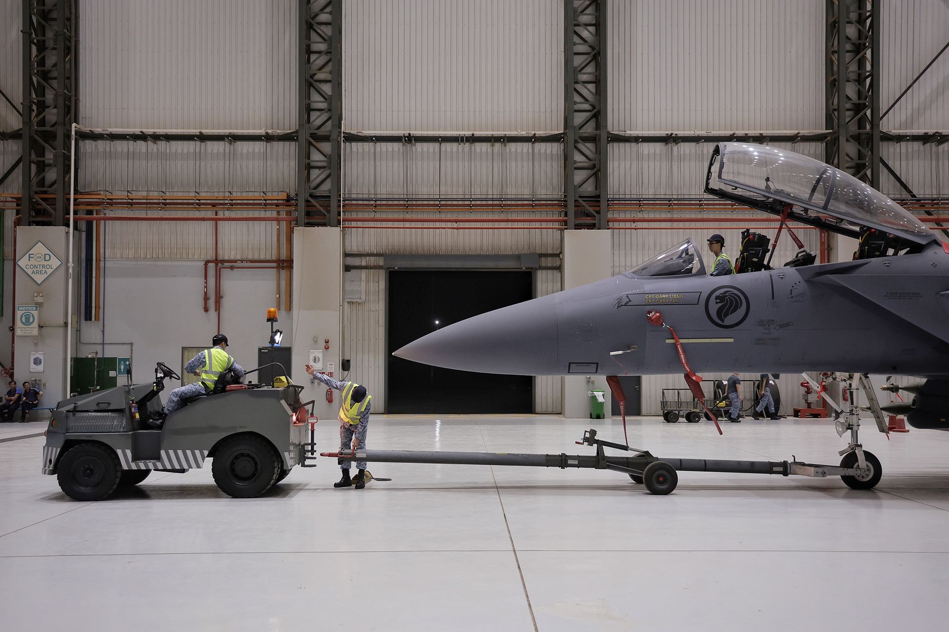 RSAF servicemen preparing to tow the F-15SG from the hangar in Changi Air Base (East) on Feb 13. ST PHOTO: KEVIN LIM