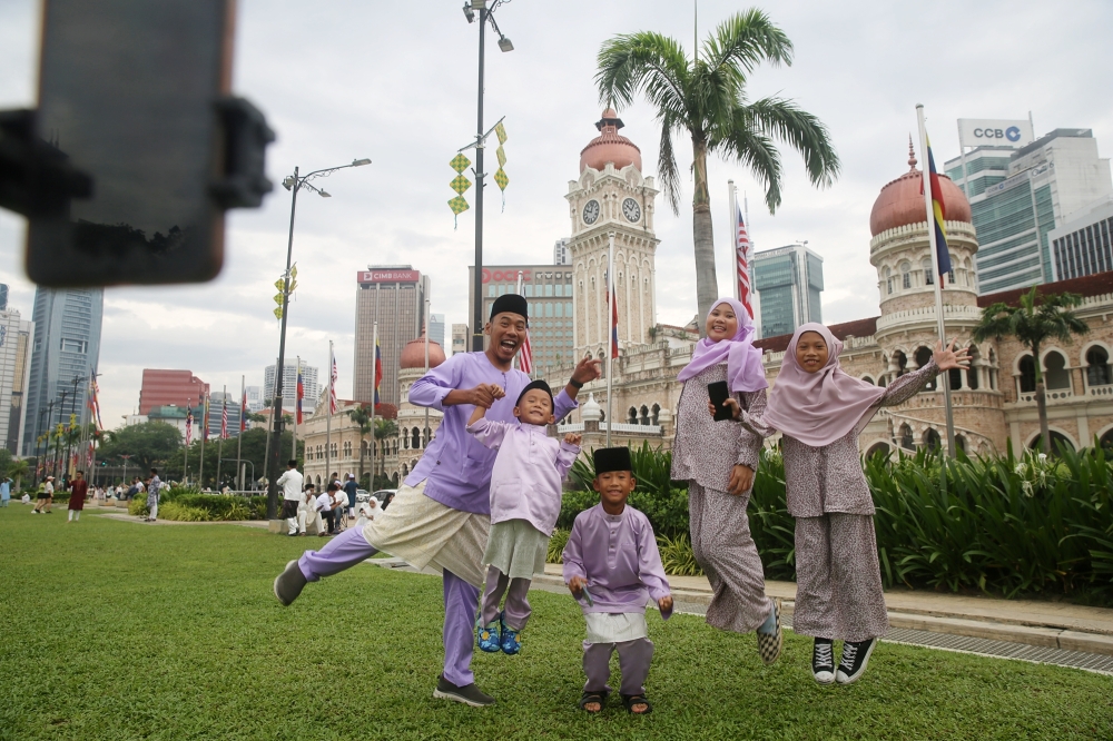 People taking the advantage of the Hari Raya Aldifitri holidays to visit and take pictures at the Dataran Merdeka in Kuala Lumpur April 10, 2024. 