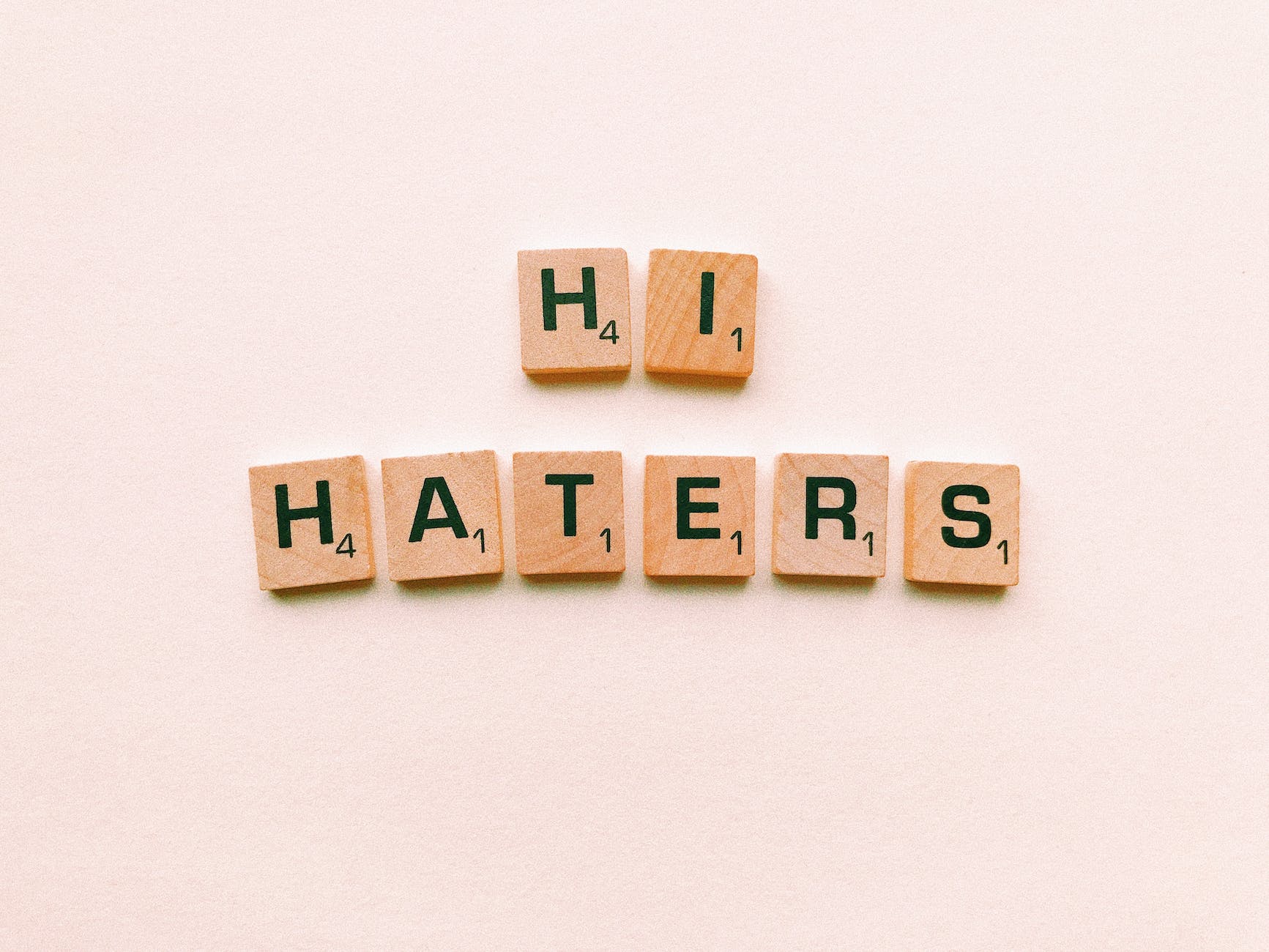 hi haters scrabble tiles on white surface