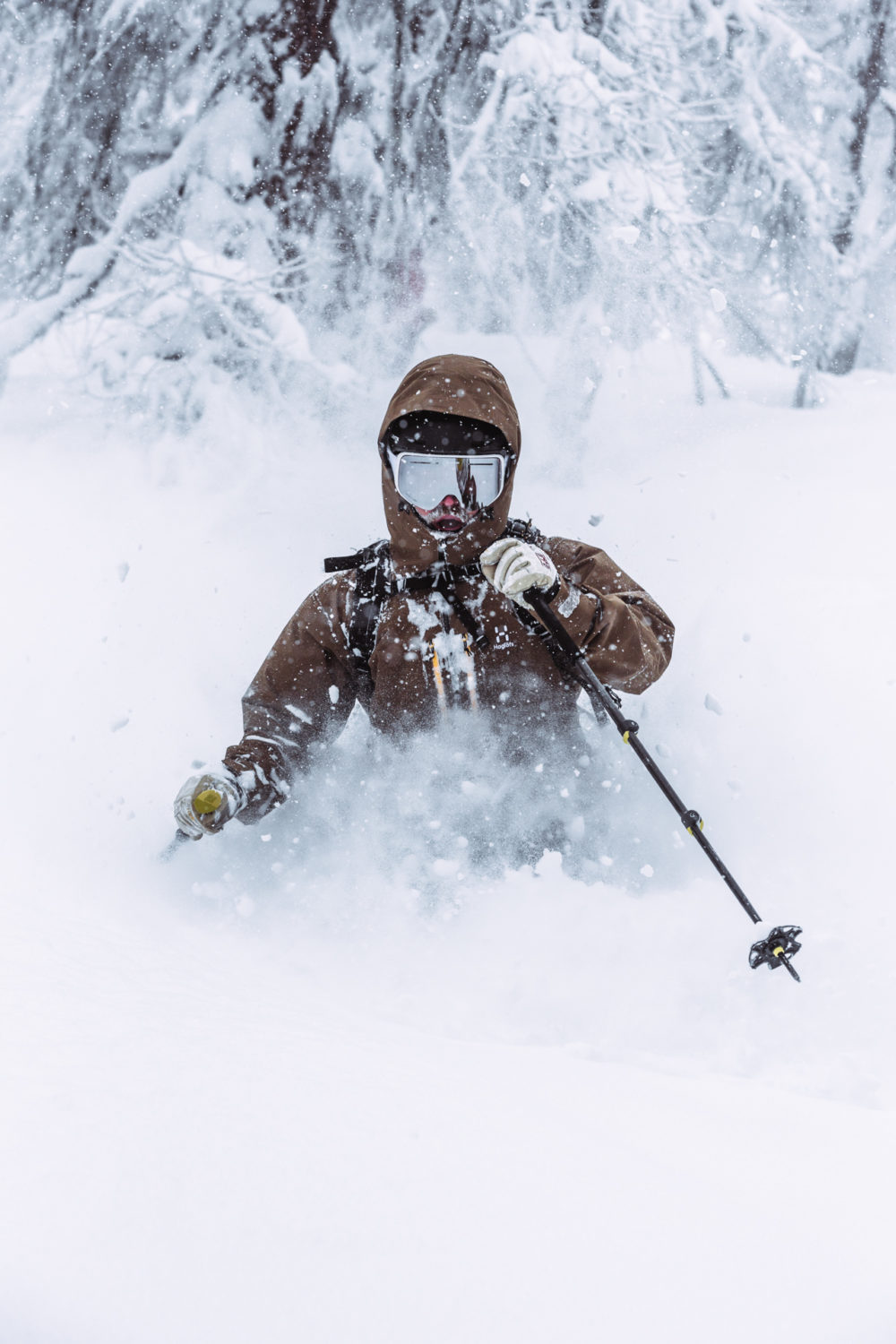 A man skiing down a snow covered slope. Haglöfs Winter 2021.