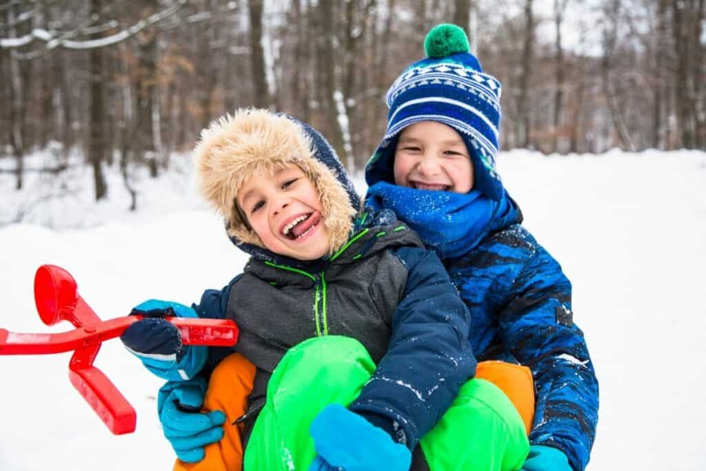 Glade barn med varme vinterklær