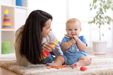 91609376 - mom and baby playing musical toys at home