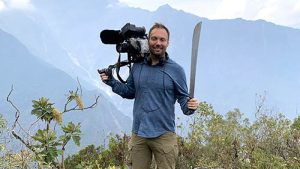 Morten Bastholm with camera and machete in Peru