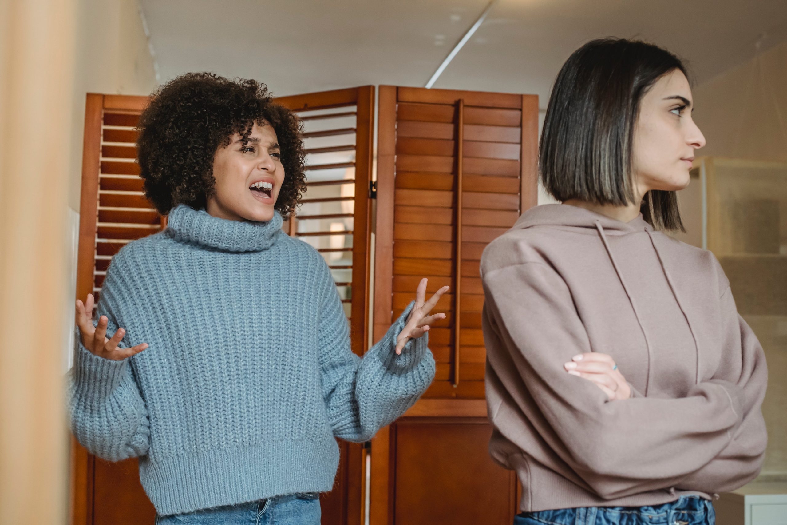 Two young multii-ethnic women disagreeing