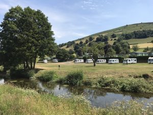 A view of Parc Farm Caravan Park from across the river