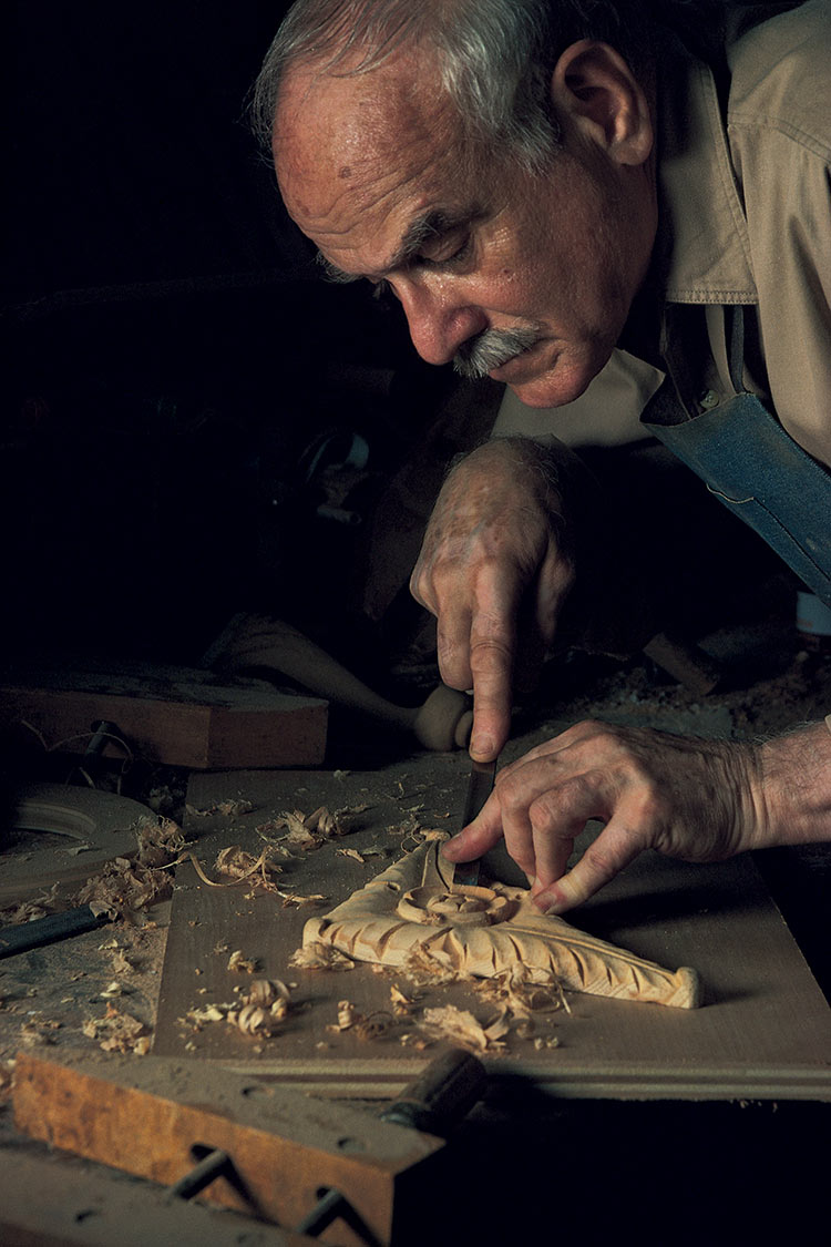 Broadway carpenter hand carving a corbel