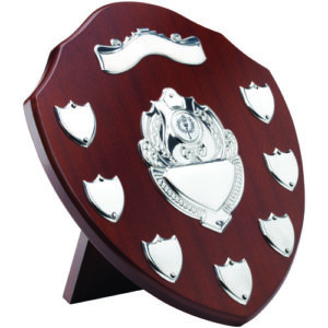 MAHOGANY SHIELD WITH CHROME FRONTS AND 7 RECORD SHIELDS (1in CENTRE) - 11in