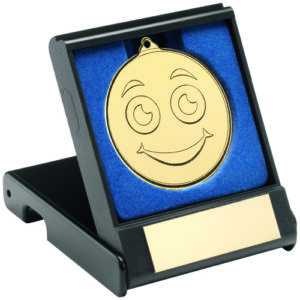 BLACK PLASTIC BOX WITH 50mm GOLD SMILEY FACE MEDAL TROPHY - 3.5in