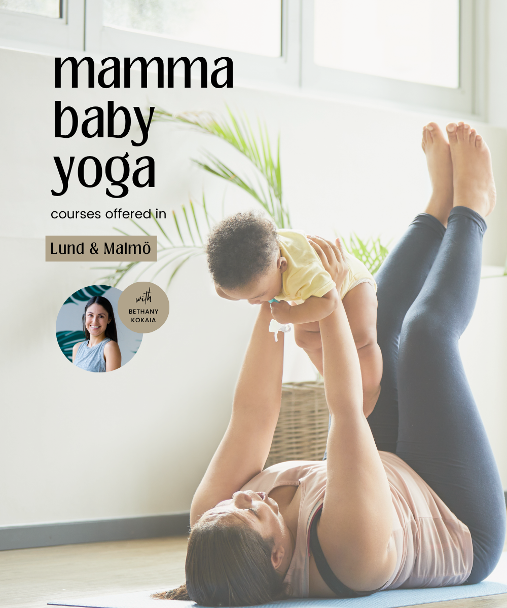 a mother practicing mamma baby yoga and holding her baby up above her chest in a yoga pose of legs up the wall or reverse bug pose. the mother is happy and smiling to her baby. the photo has text that says "mamma baby yoga with bethany koakaia"