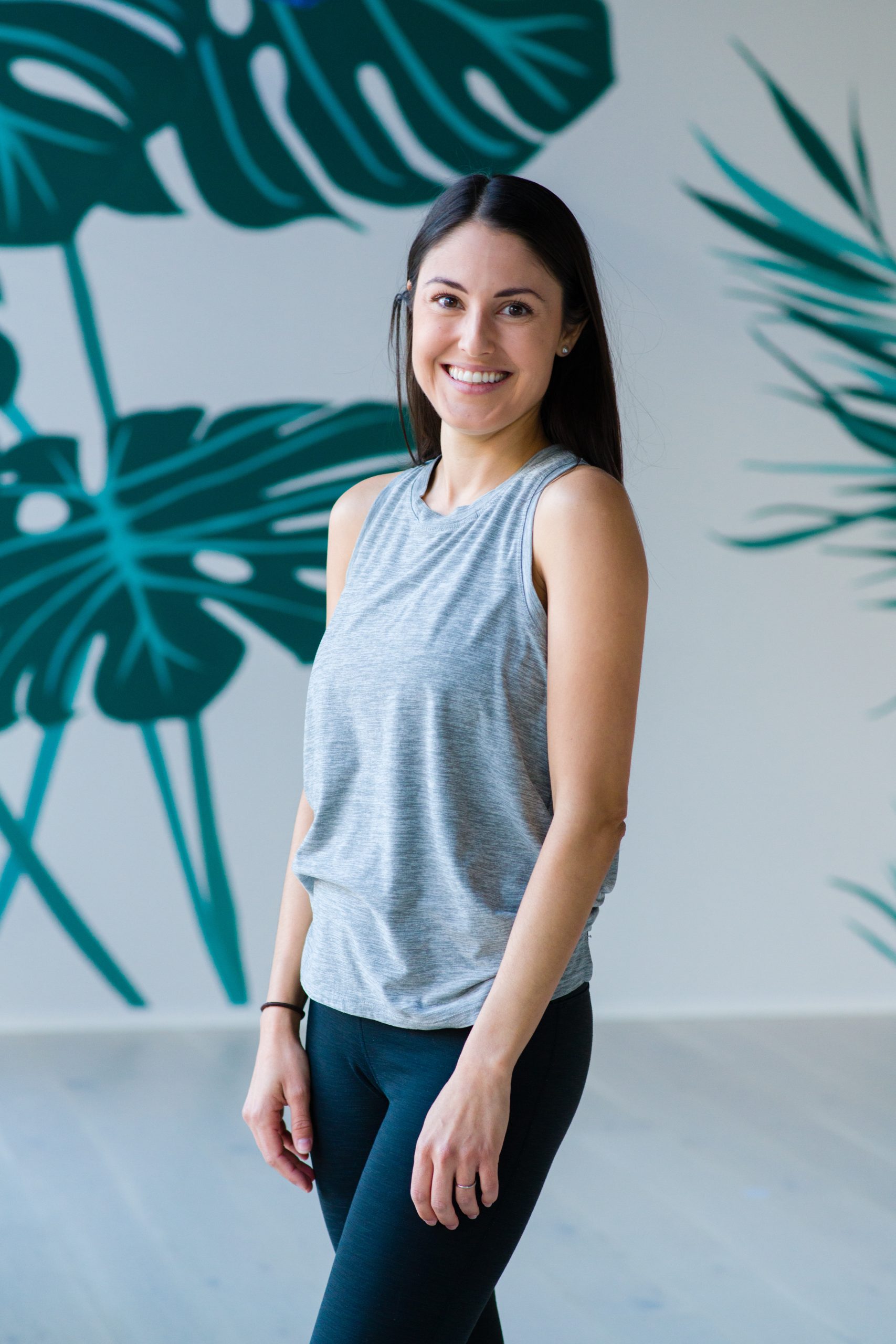 a woman standing and smiling.