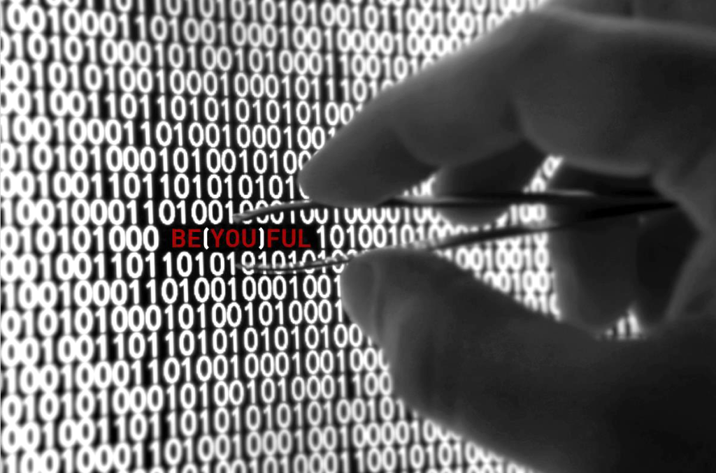 Close-up of a hand holding tweezers, isolating the word ‘BE(YOU)FULL’ in red text within a dense matrix of binary code. Digital concept by Carlos Simpson for the BE(YOU)FULL initiative, symbolising precision, identity, and strategic thinking.