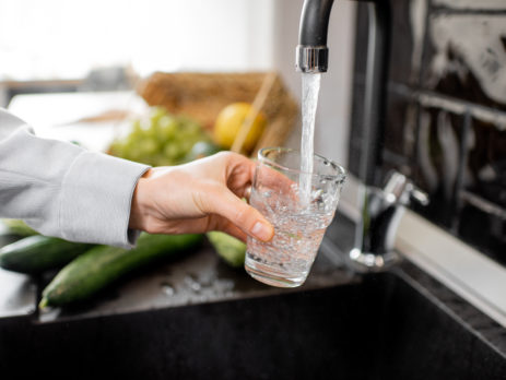 Filling drinking glass with tap water