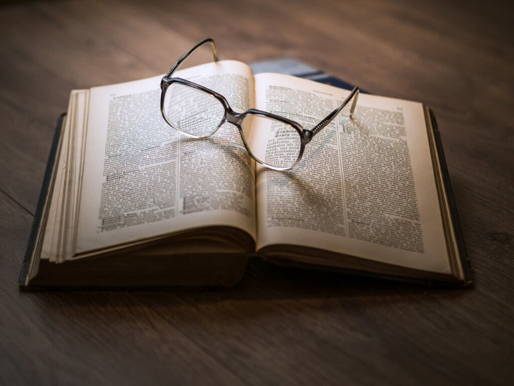 Book with glasses on top