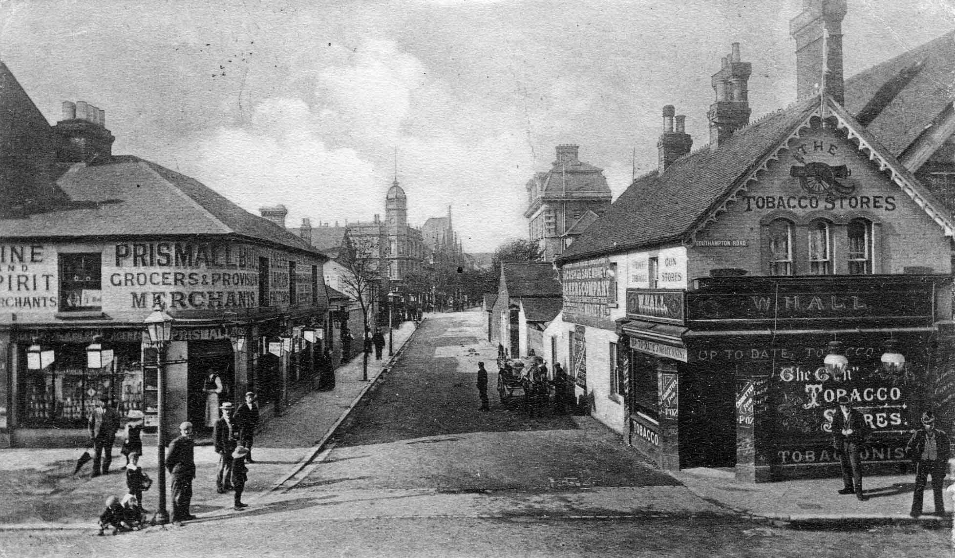 A black and white photo of a street with buildings and people Description automatically generated with low confidence