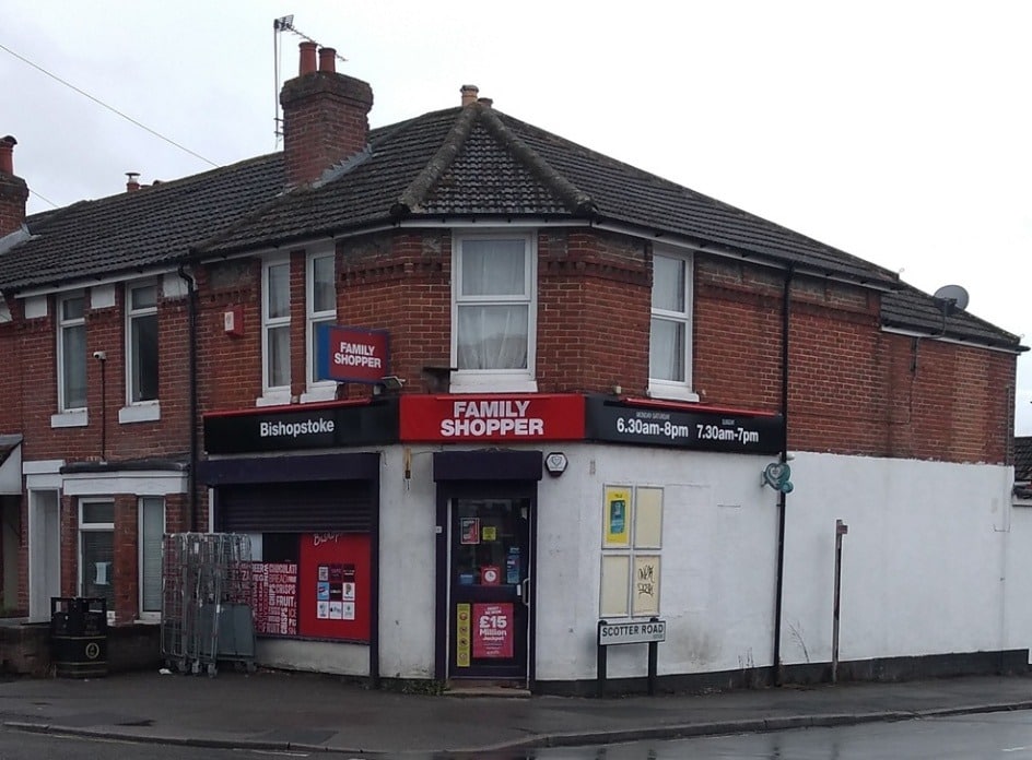 A brick building with a store front AI-generated content may be incorrect.