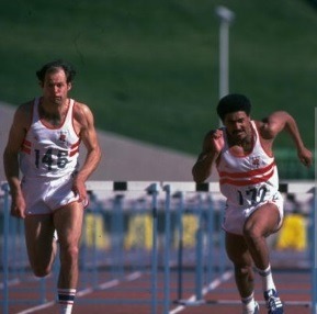 A couple of men running on a track Description automatically generated with low confidence