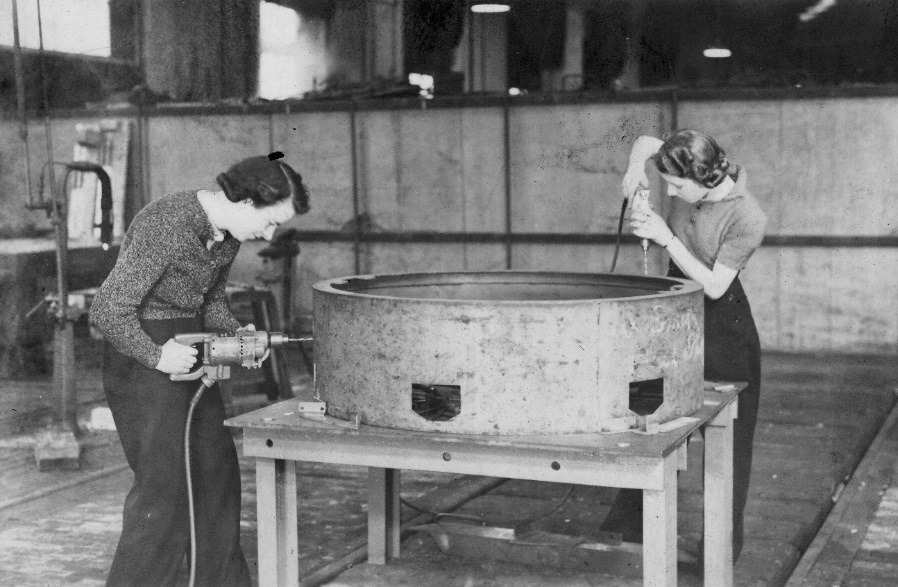 A couple of women working in a factory Description automatically generated with low confidence