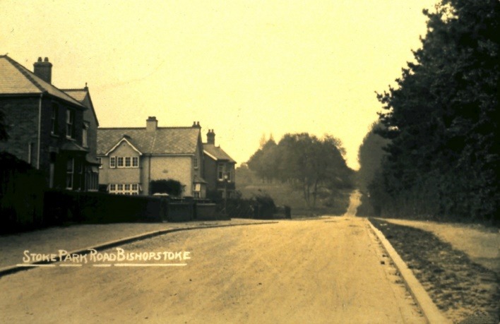 A dirt road with houses on either side of it Description automatically generated with medium confidence