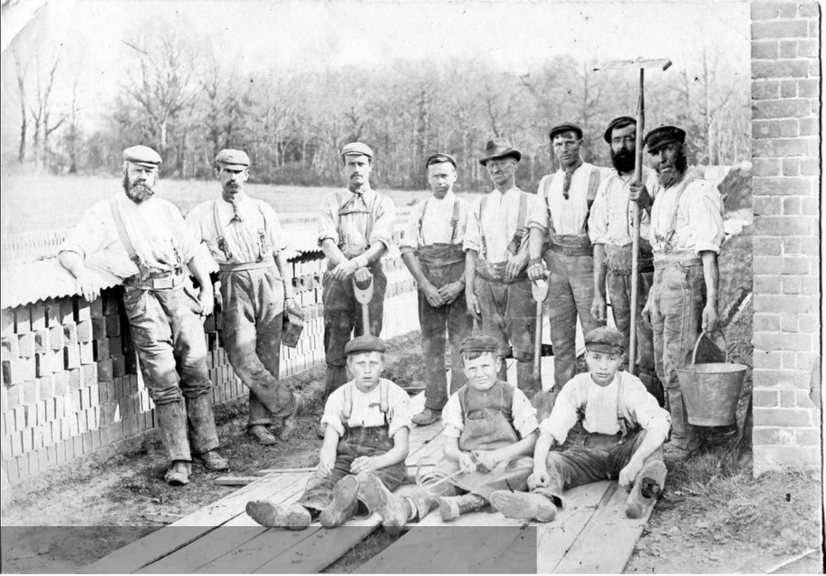 A group of men posing for a photo Description automatically generated with medium confidence