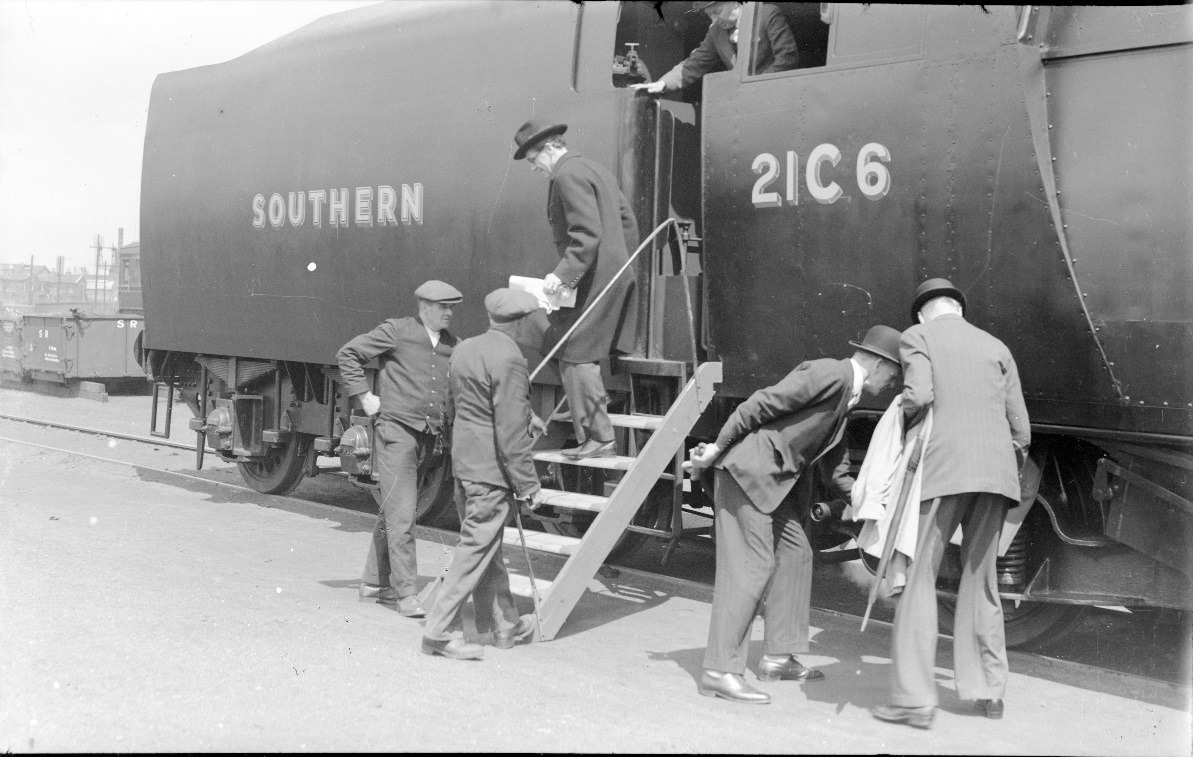 A group of men working on a train Description automatically generated with medium confidence