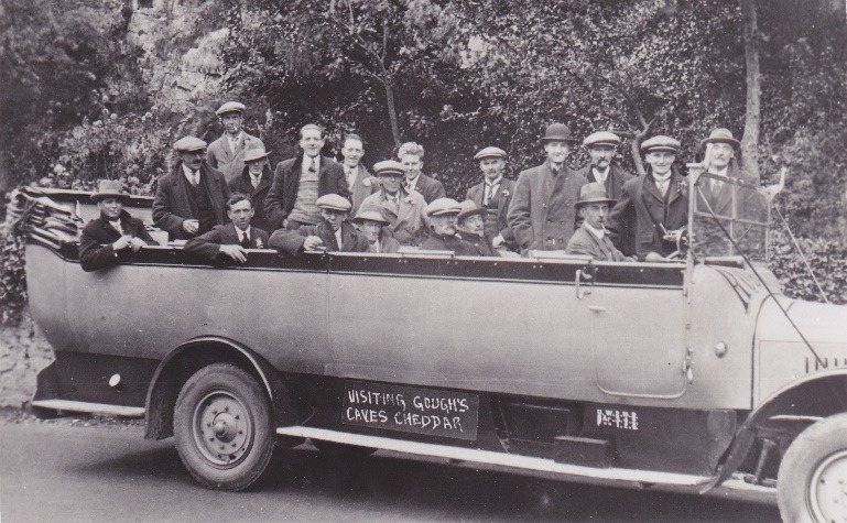 A group of people sitting on a military vehicle Description automatically generated with low confidence