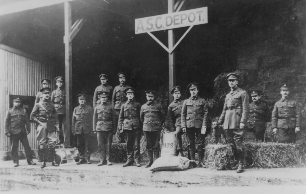 A group of people standing in front of a sign Description automatically generated with low confidence