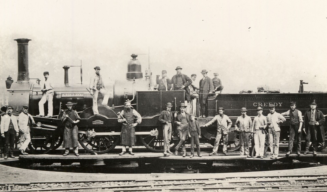 A group of people standing on a train Description automatically generated with low confidence