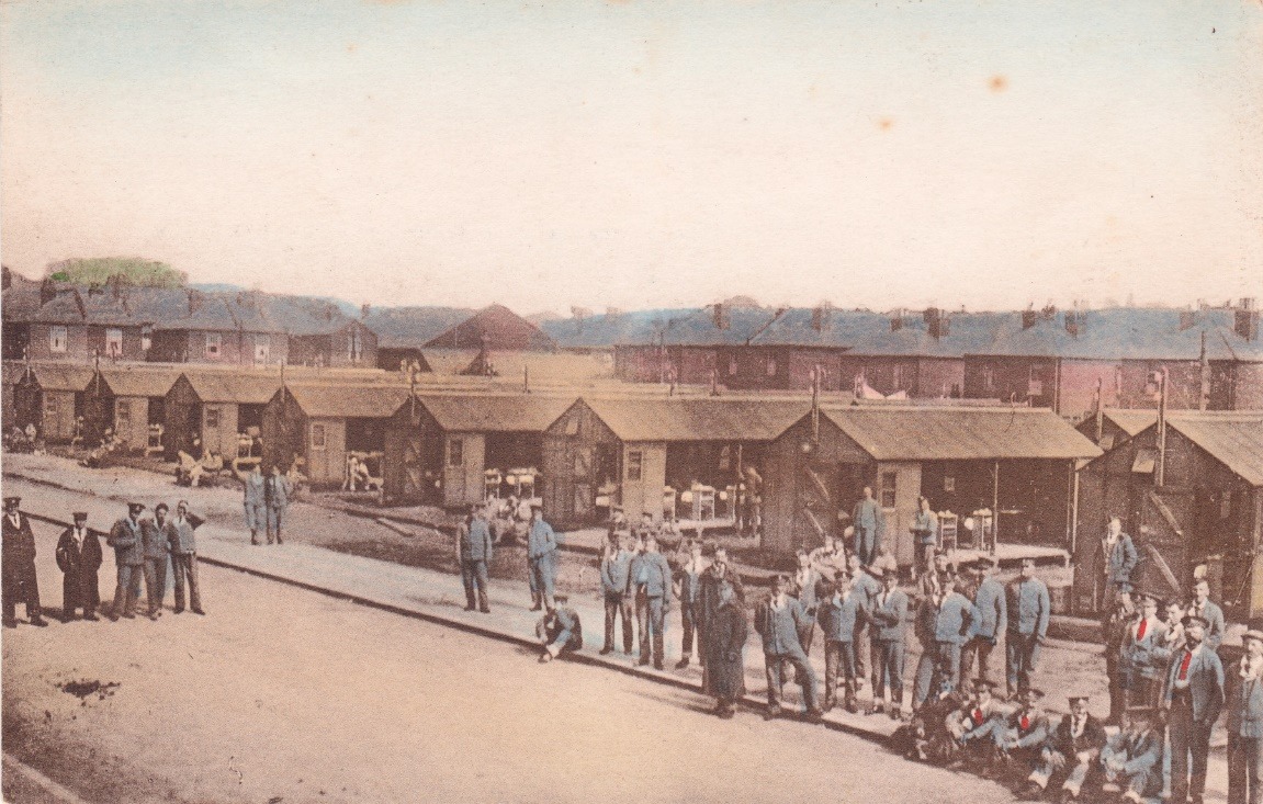 A group of people standing outside a building Description automatically generated with medium confidence