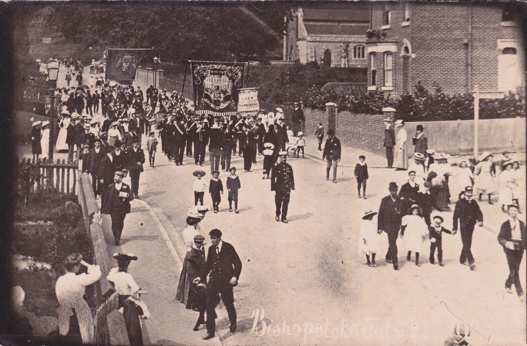 A group of people walking down a street Description automatically generated with low confidence