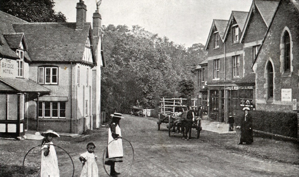 A group of people walking down a street with a horse and buggy Description automatically generated with low confidence