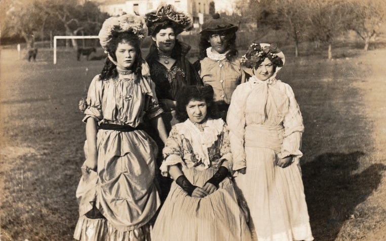 A group of women in dresses Description automatically generated with low confidence