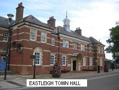 A large brick building with a clock tower Description automatically generated with medium confidence