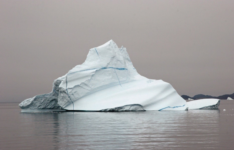 A large iceberg in the water Description automatically generated with medium confidence