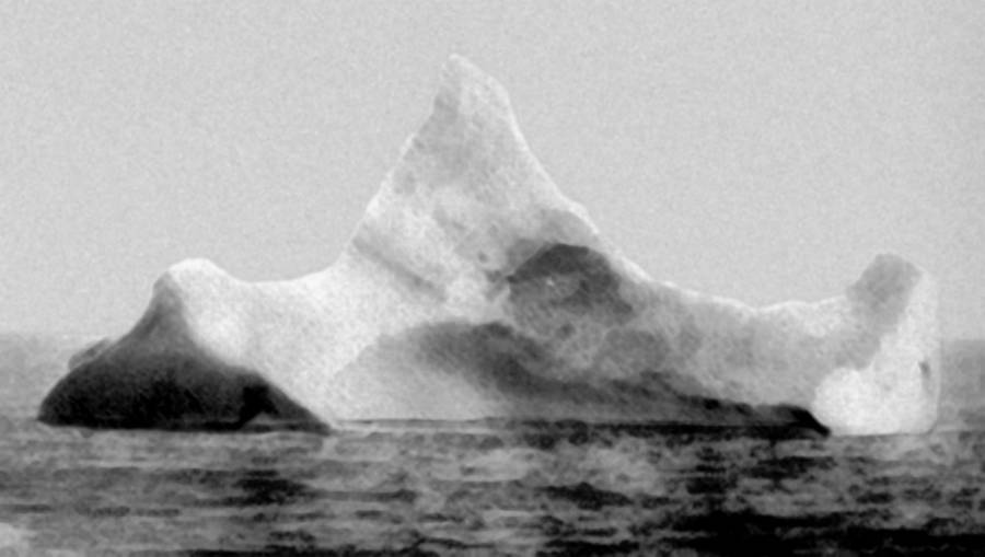 A large iceberg in the water Description automatically generated with low confidence