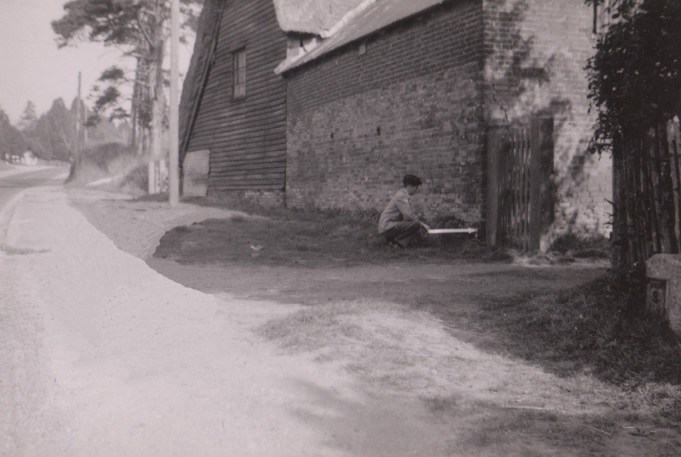 A person sitting on the ground outside of a building AI-generated content may be incorrect.