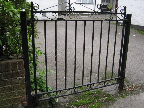 A picture containing outdoor, building, gate, area Description automatically generated