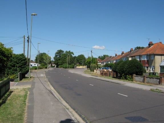 A road with houses along it Description automatically generated with medium confidence