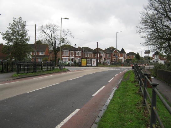 A road with houses along it Description automatically generated with low confidence