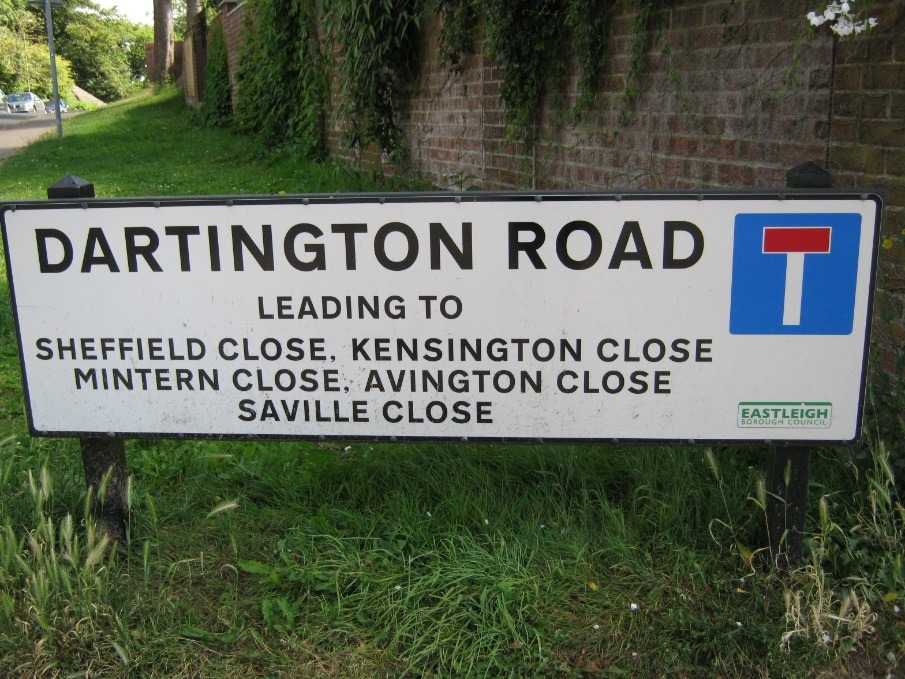 A sign in front of a brick wall Description automatically generated with low confidence