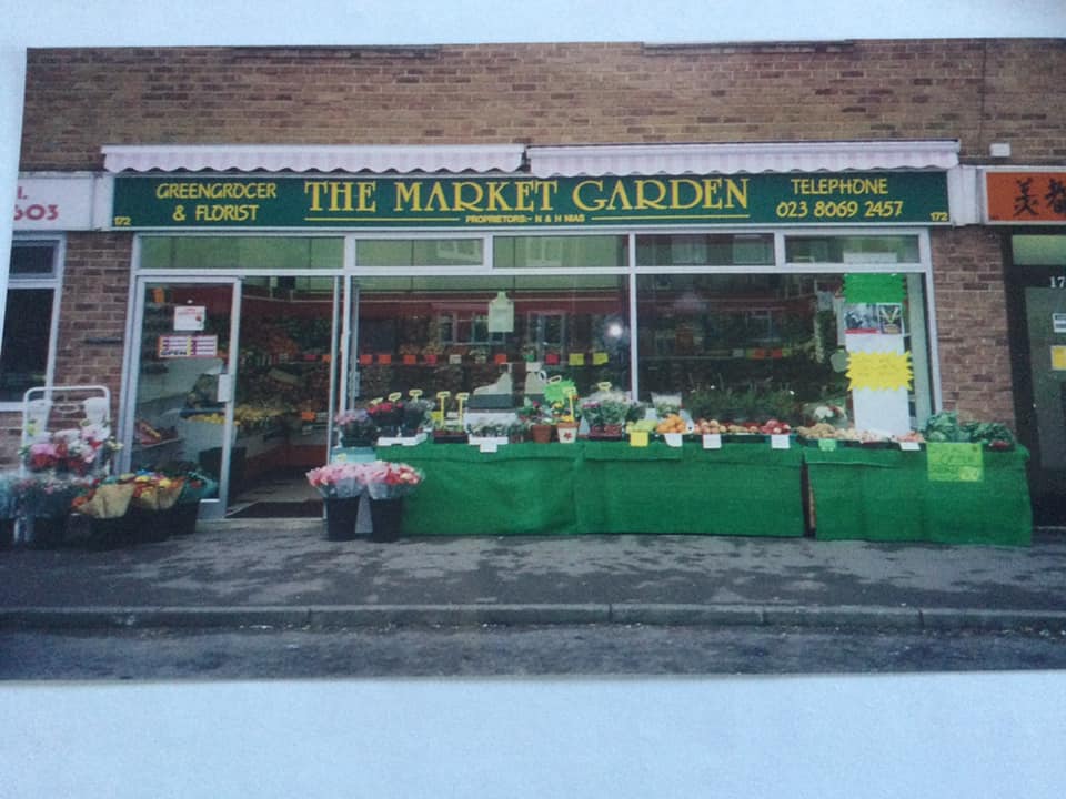 A store front with a green banner AI-generated content may be incorrect.