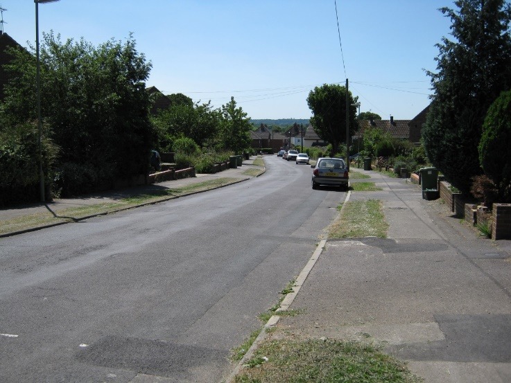 A street with cars on it Description automatically generated with low confidence