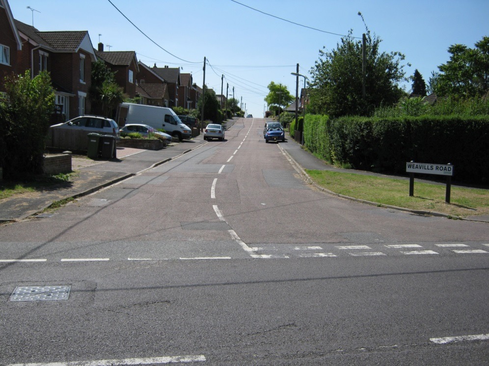 A street with cars on it Description automatically generated with low confidence