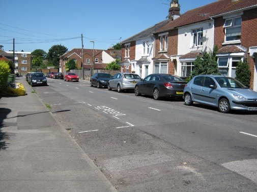 A street with cars parked along it Description automatically generated with medium confidence