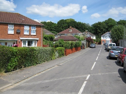 A street with cars parked along it Description automatically generated with low confidence