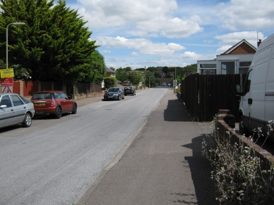 A street with cars parked along it Description automatically generated with medium confidence