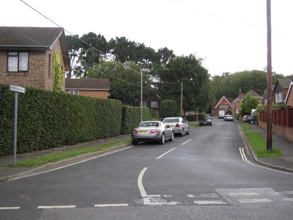 A street with cars parked on the side Description automatically generated with low confidence